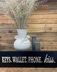 "Keys. Wallet. Phone. Kiss." Sign