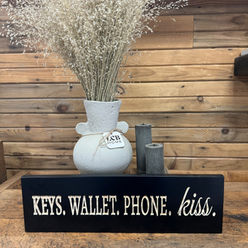 "Keys. Wallet. Phone. Kiss." Sign