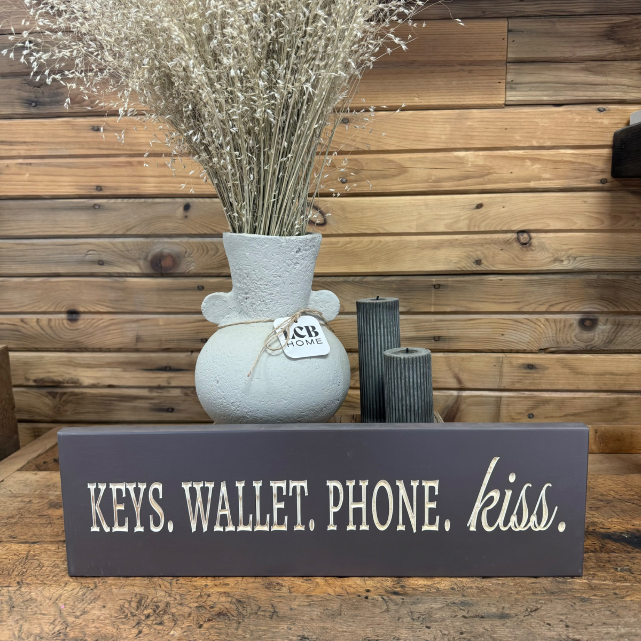 "Keys. Wallet. Phone. Kiss." Sign