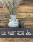 "Keys. Wallet. Phone. Kiss." Sign